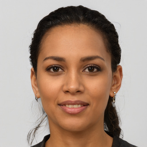 Joyful latino young-adult female with long  brown hair and brown eyes