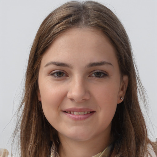 Joyful white young-adult female with long  brown hair and brown eyes