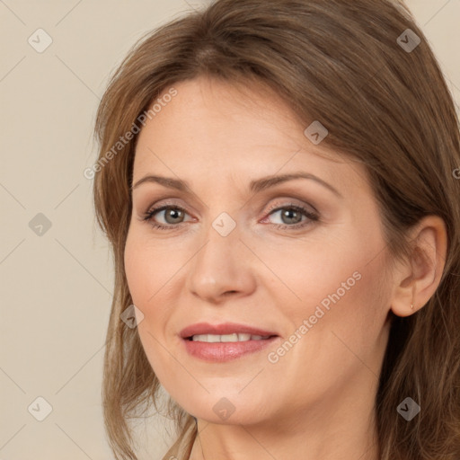 Joyful white adult female with long  brown hair and brown eyes