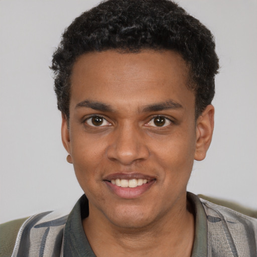 Joyful black young-adult male with short  brown hair and brown eyes