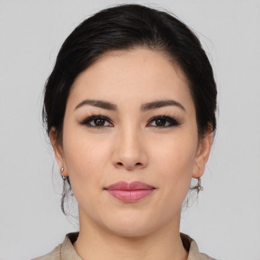 Joyful white young-adult female with medium  black hair and brown eyes