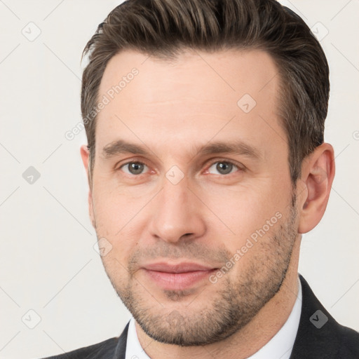 Joyful white young-adult male with short  brown hair and brown eyes