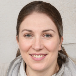 Joyful white young-adult female with medium  brown hair and blue eyes