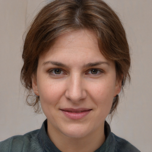 Joyful white young-adult female with medium  brown hair and brown eyes