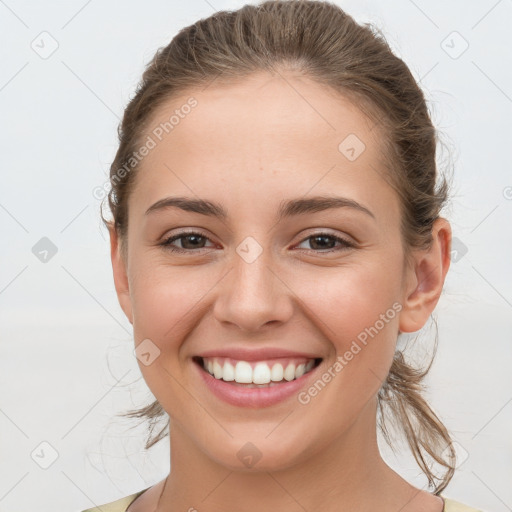 Joyful white young-adult female with medium  brown hair and grey eyes