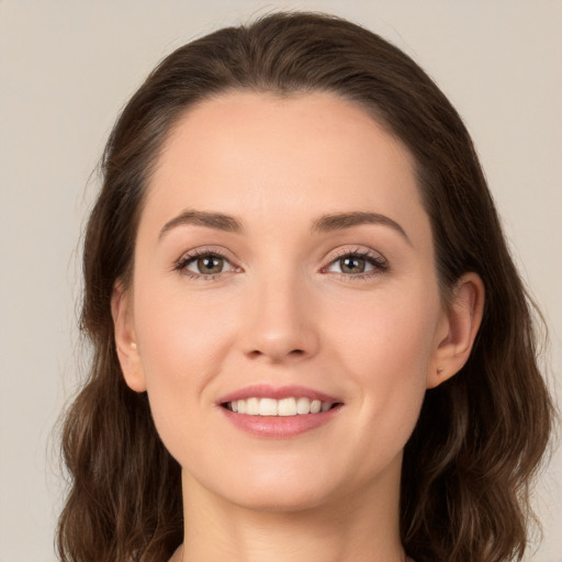 Joyful white young-adult female with long  brown hair and brown eyes