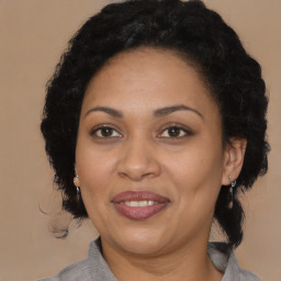 Joyful black adult female with medium  brown hair and brown eyes