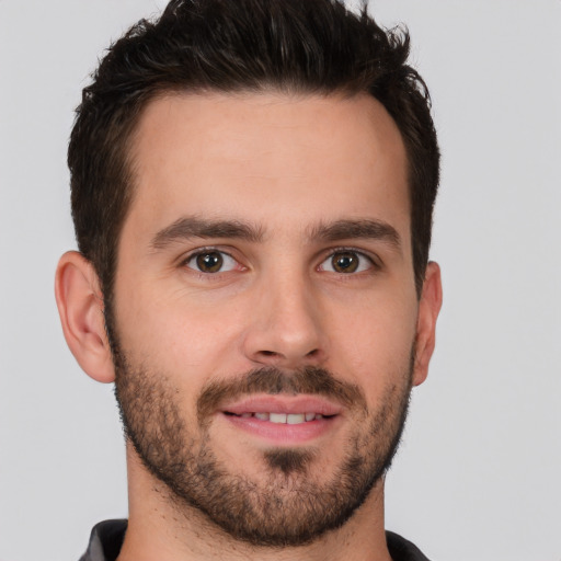 Joyful white young-adult male with short  brown hair and brown eyes