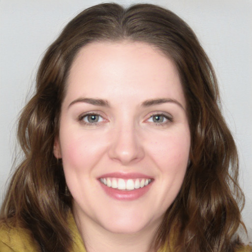 Joyful white young-adult female with medium  brown hair and green eyes