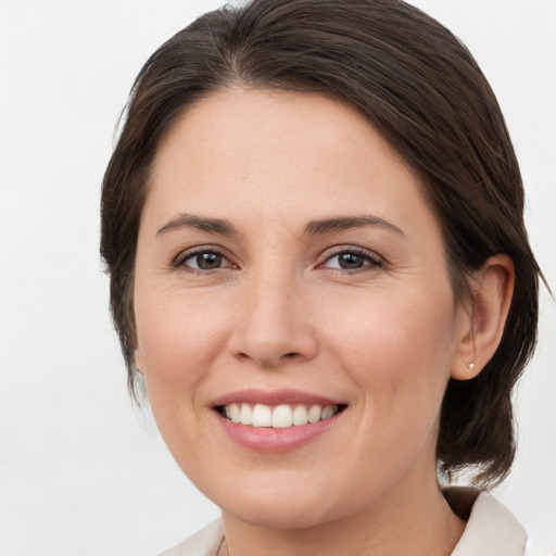 Joyful white young-adult female with medium  brown hair and brown eyes