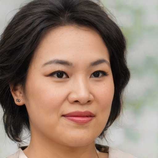 Joyful asian young-adult female with medium  brown hair and brown eyes