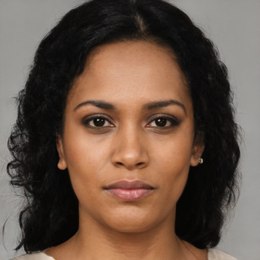 Joyful black young-adult female with medium  black hair and brown eyes