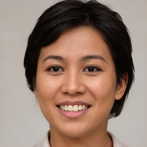 Joyful white young-adult female with medium  brown hair and brown eyes