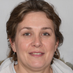 Joyful white adult female with medium  brown hair and blue eyes