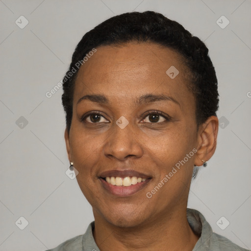 Joyful black adult female with short  black hair and brown eyes