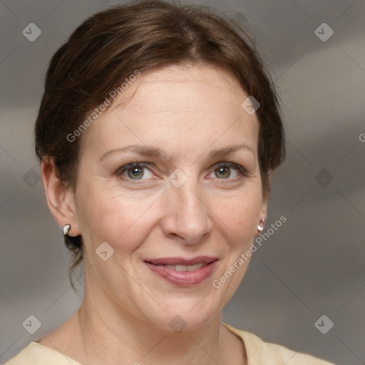 Joyful white adult female with medium  brown hair and grey eyes