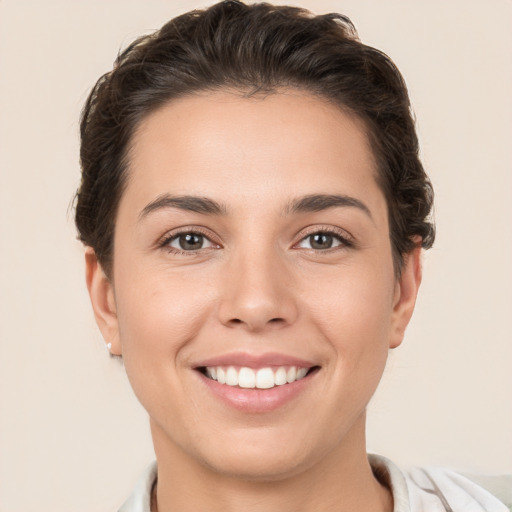 Joyful white young-adult female with short  brown hair and brown eyes