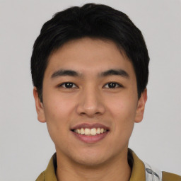 Joyful asian young-adult male with short  black hair and brown eyes