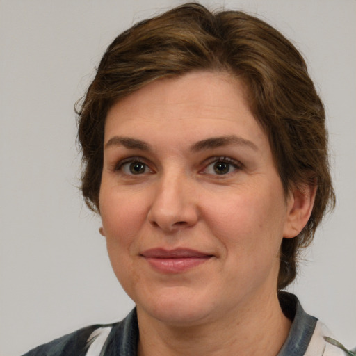 Joyful white adult female with medium  brown hair and grey eyes