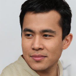 Joyful asian young-adult male with short  black hair and brown eyes