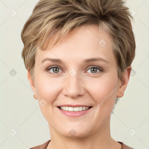 Joyful white young-adult female with short  brown hair and grey eyes