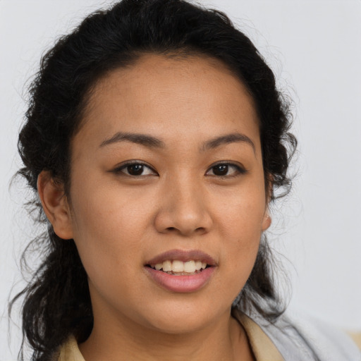 Joyful latino young-adult female with long  brown hair and brown eyes