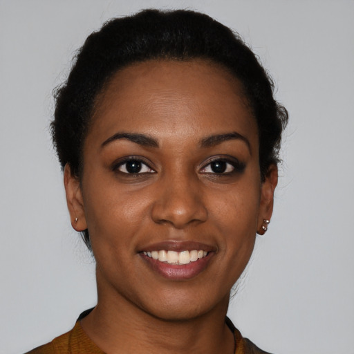 Joyful black young-adult female with short  brown hair and brown eyes