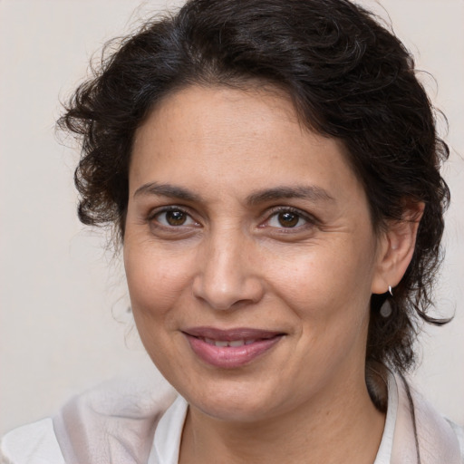 Joyful white adult female with medium  brown hair and brown eyes