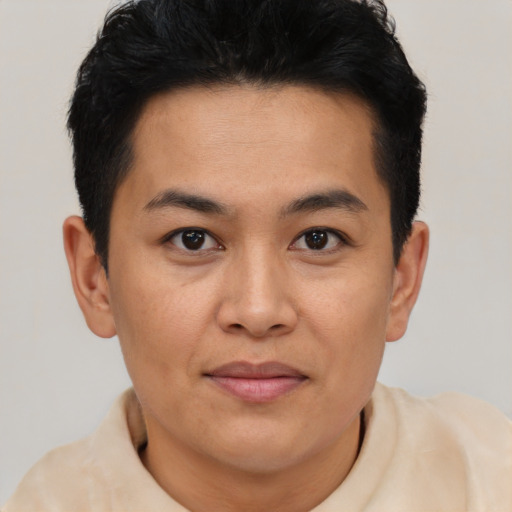 Joyful latino young-adult male with short  brown hair and brown eyes