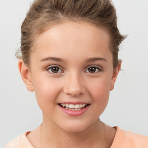 Joyful white child female with short  brown hair and brown eyes