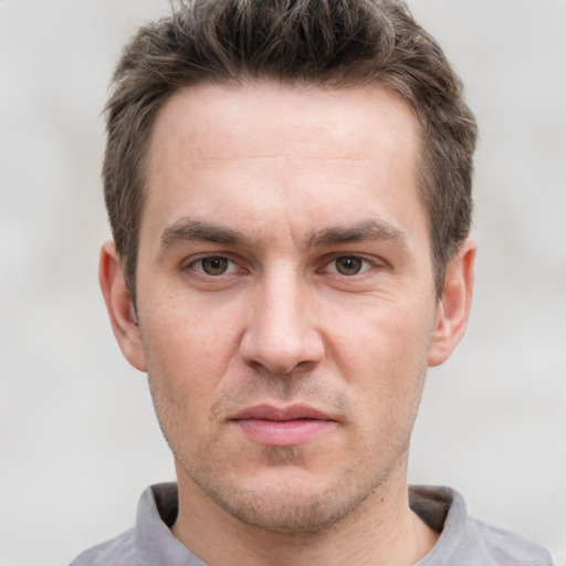 Joyful white adult male with short  brown hair and grey eyes