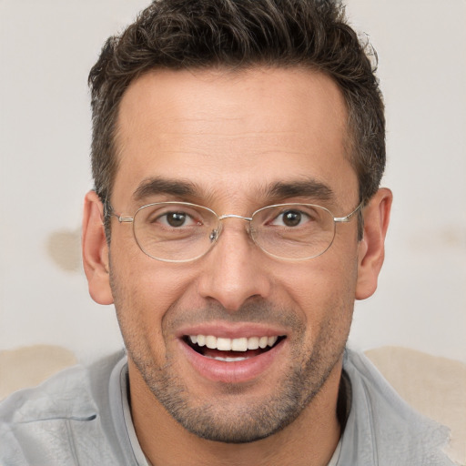 Joyful white adult male with short  brown hair and brown eyes