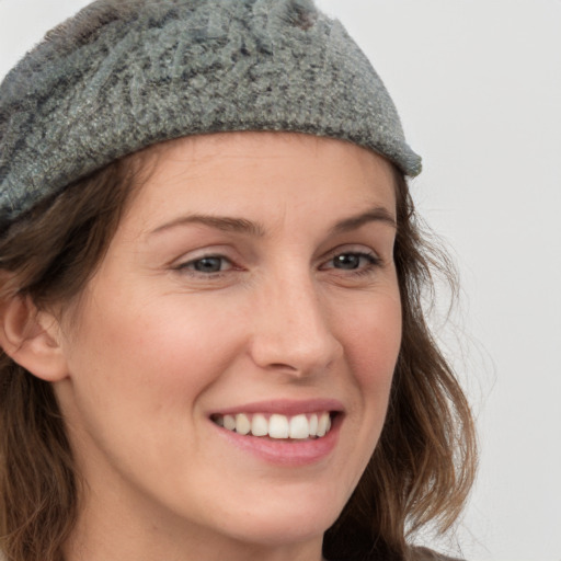 Joyful white young-adult female with long  brown hair and grey eyes