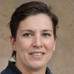 Joyful white adult female with medium  brown hair and grey eyes