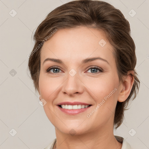 Joyful white young-adult female with medium  brown hair and grey eyes