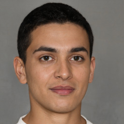 Joyful latino young-adult male with short  brown hair and brown eyes