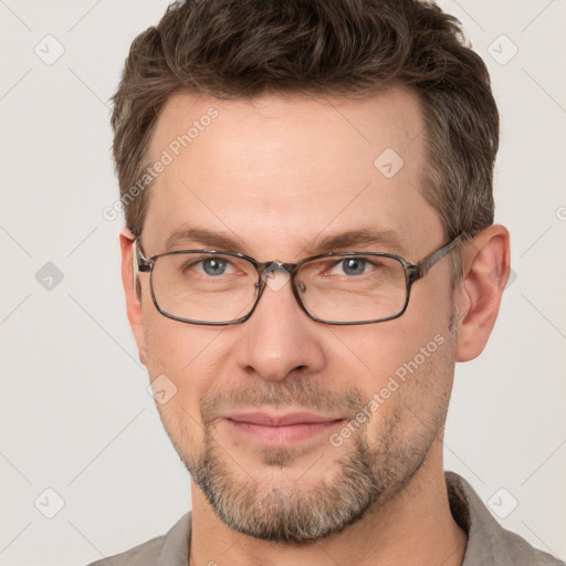 Joyful white adult male with short  brown hair and grey eyes