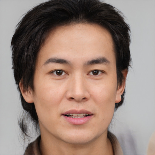 Joyful white young-adult male with medium  brown hair and brown eyes
