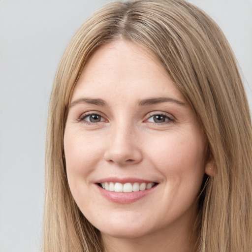 Joyful white young-adult female with long  brown hair and brown eyes