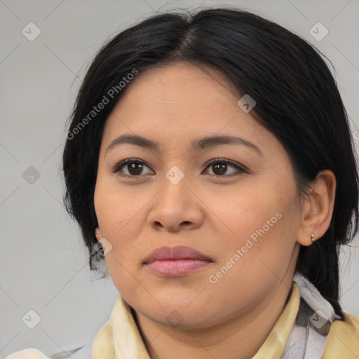 Joyful latino young-adult female with medium  brown hair and brown eyes