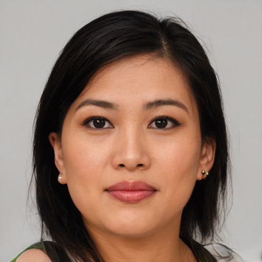 Joyful asian young-adult female with long  brown hair and brown eyes