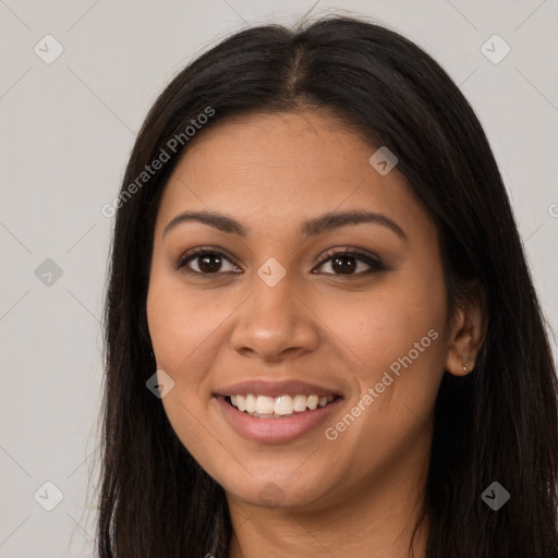 Joyful latino young-adult female with long  brown hair and brown eyes