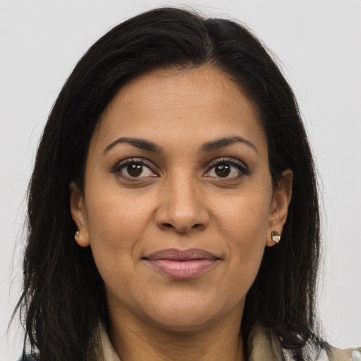 Joyful latino adult female with long  brown hair and brown eyes