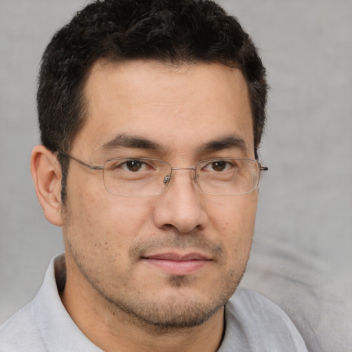 Joyful white adult male with short  brown hair and brown eyes