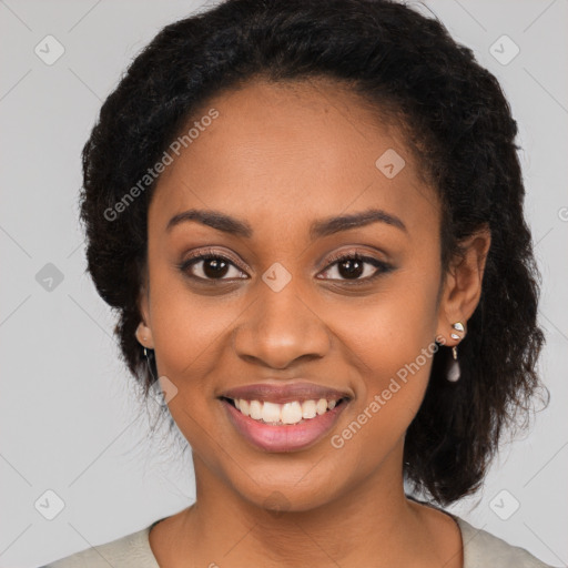 Joyful black young-adult female with long  black hair and brown eyes