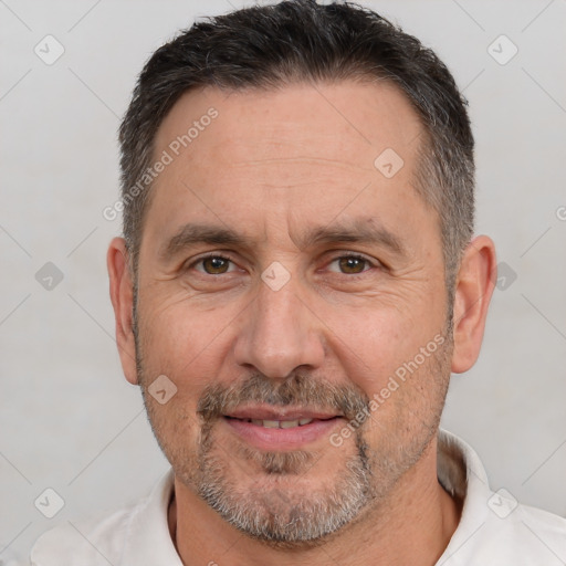 Joyful white adult male with short  brown hair and brown eyes