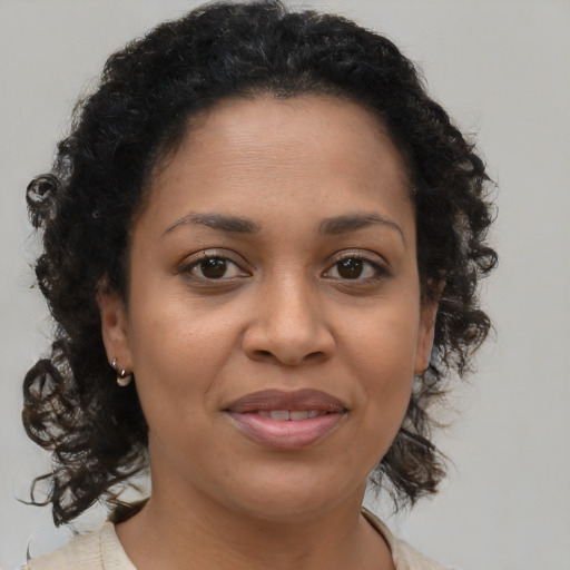 Joyful black young-adult female with medium  brown hair and brown eyes