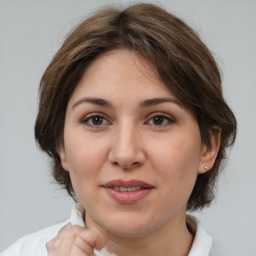 Joyful white adult female with medium  brown hair and brown eyes