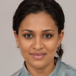 Joyful black young-adult female with medium  brown hair and brown eyes