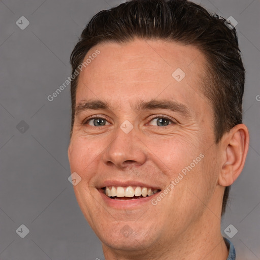 Joyful white adult male with short  brown hair and brown eyes